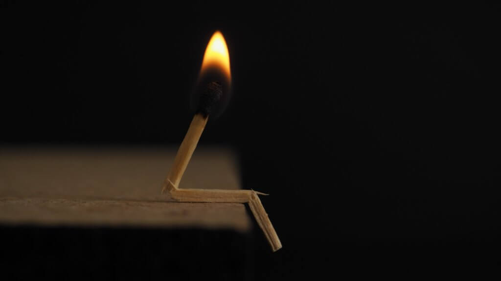 Broken and burning matchstick representing burned-out employee