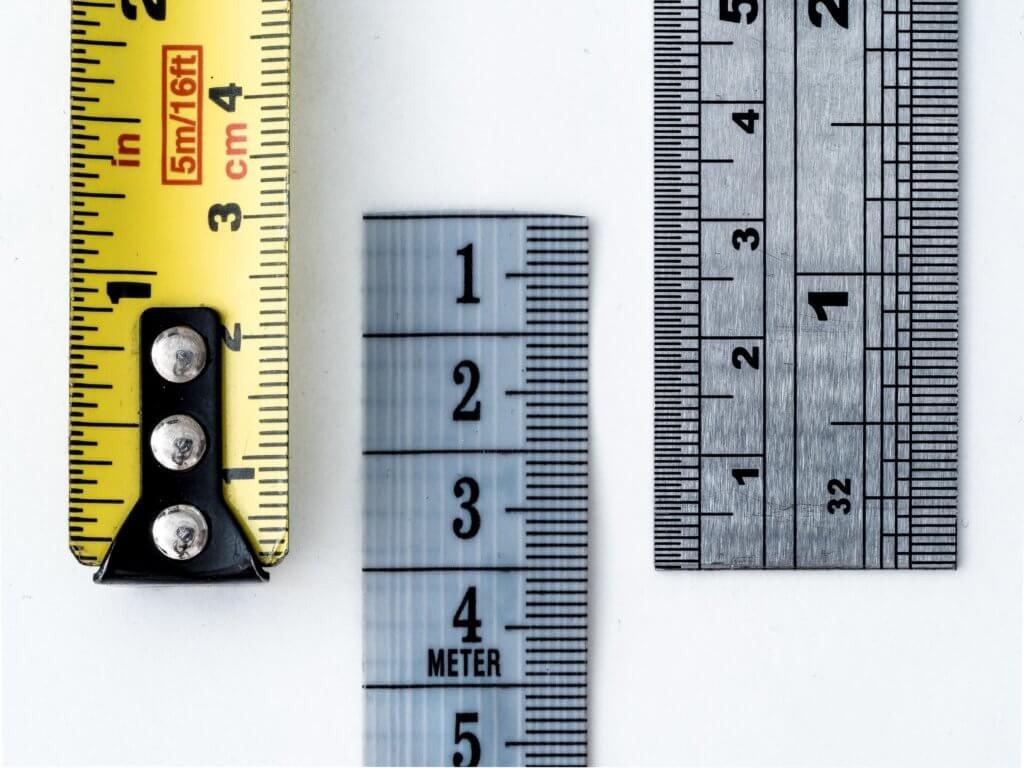 Three tape measures and rulers
